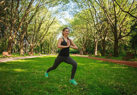 Frau macht Sport auf einer Wiese